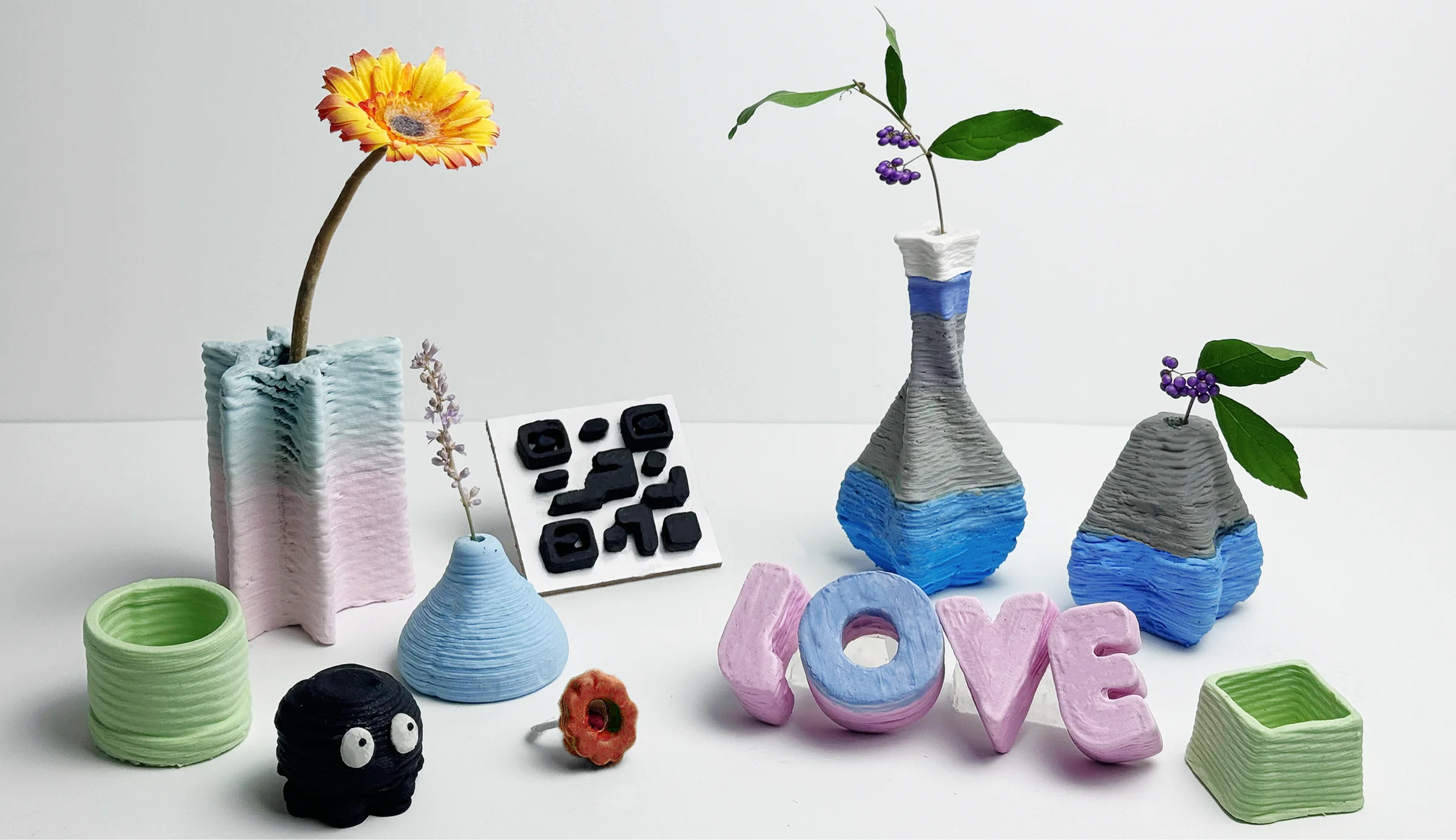A family of colorful 3D-printed soap vessels, letters, and interactive objects